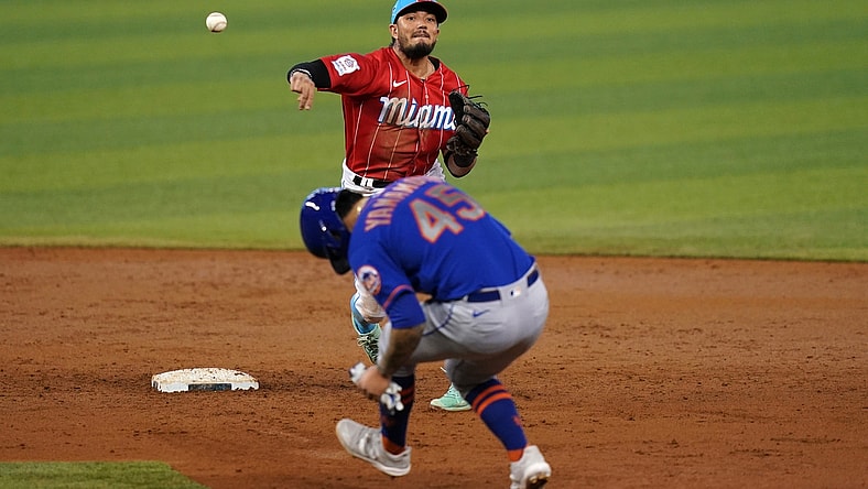 May 23, 2021; Miami, Florida, USA; Miami Marlins shortstop Miguel Rojas (19) gets the force out of New York Mets starting pitcher Jordan Yamamoto (45) while turning a double play in the 3rd inning at loanDepot park. Mandatory Credit: Jasen Vinlove-USA TODAY Sports