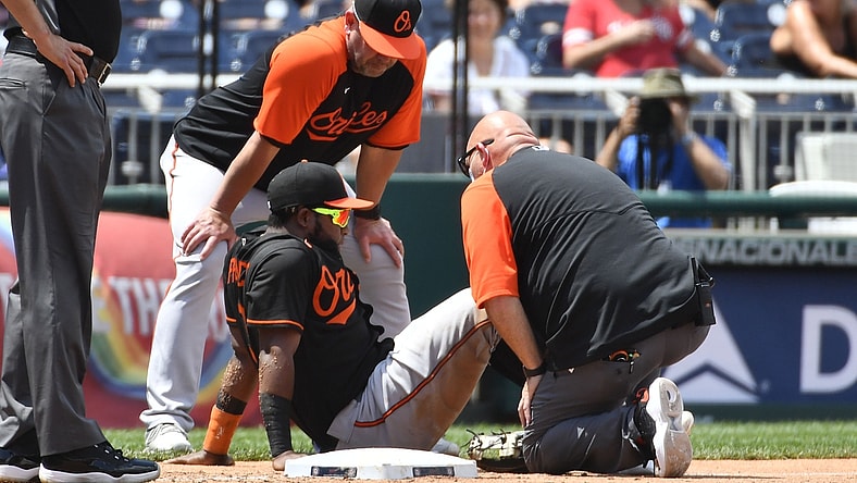 May 23, 2021; Washington, District of Columbia, USA; Baltimore Orioles third baseman Maikel Franco (3) has his leg looked at by the trainer against the Washington Nationals during the third inning at Nationals Park. Mandatory Credit: Brad Mills-USA TODAY Sports
