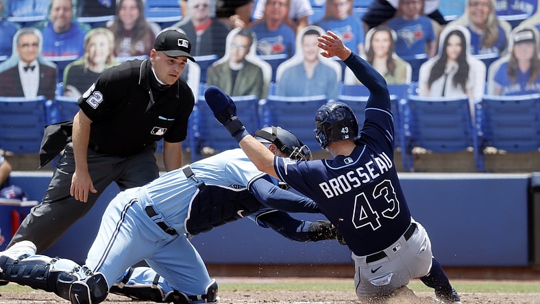 May 23, 2021; Dunedin, Florida, CAN;  Toronto Blue Jays catcher Danny Jansen (9) tags out Tampa Bay Rays third baseman Mike Brosseau (43) at home plate during the fourth inning at TD Ballpark. Mandatory Credit: Kim Klement-USA TODAY Sports