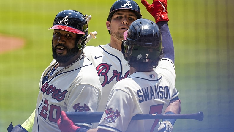 May 23, 2021; Cumberland, Georgia, USA; Atlanta Braves third baseman Austin Riley (27) (rear) reacts with left fielder Marcell Ozuna (20) and shortstop Dansby Swanson (7) after hitting a two run home run against the Pittsburgh Pirates during the first inning at Truist Park. Mandatory Credit: Dale Zanine-USA TODAY Sports