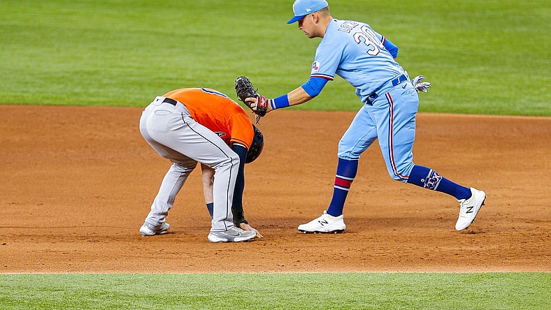 May 23, 2021; Arlington, Texas, USA; Texas Rangers first baseman Nate Lowe (30) tags out Houston Astros left fielder Kyle Tucker (30) during a pick off throw in the second inning at Globe Life Field. Mandatory Credit: Andrew Dieb-USA TODAY Sports