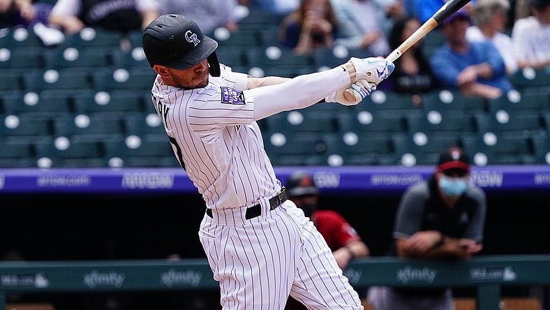 May 23, 2021; Denver, Colorado, USA; Colorado Rockies shortstop Trevor Story (27) RBI singles in the second inning against the against the Arizona Diamondbacks at Coors Field. Mandatory Credit: Ron Chenoy-USA TODAY Sports