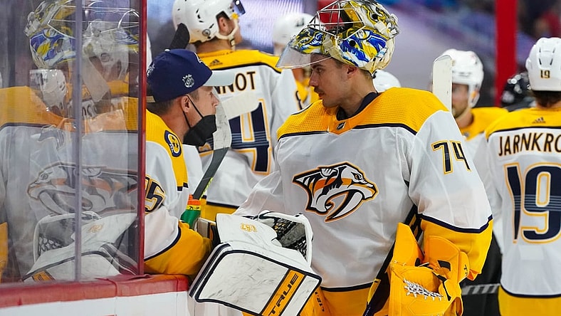 May 17, 2021; Raleigh, North Carolina, USA; Nashville Predators goaltender Juuse Saros (74) and goaltender Pekka Rinne (35) talk at the bench against the Carolina Hurricanes in game one of the first round of the 2021 Stanley Cup Playoffs at PNC Arena. Mandatory Credit: James Guillory-USA TODAY Sports