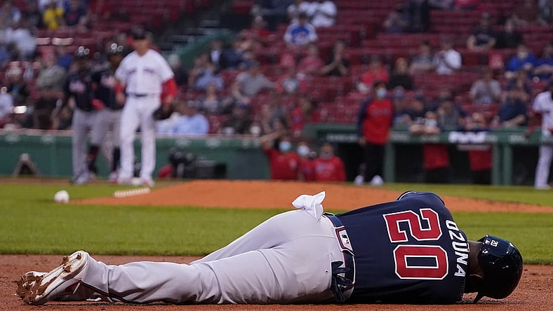 May 25, 2021; Boston, Massachusetts, USA; Atlanta Braves left fielder Marcell Ozuna (20) lays on the field with an injury after being tagged out at third during the third inning against the Boston Red Sox at Fenway Park. Mandatory Credit: David Butler II-USA TODAY Sports
