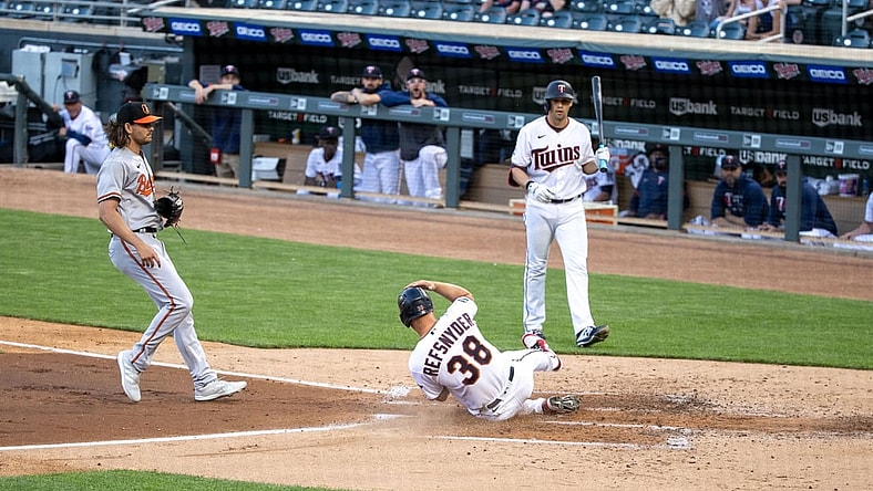 May 25, 2021; Minneapolis, Minnesota, USA; Minnesota Twins center fielder Rob Refsnyder (38) scores on a over thrown pitch by Baltimore Orioles starting pitcher Dean Kremer (64) during the second inning at Target Field. Mandatory Credit: Jordan Johnson-USA TODAY Sports