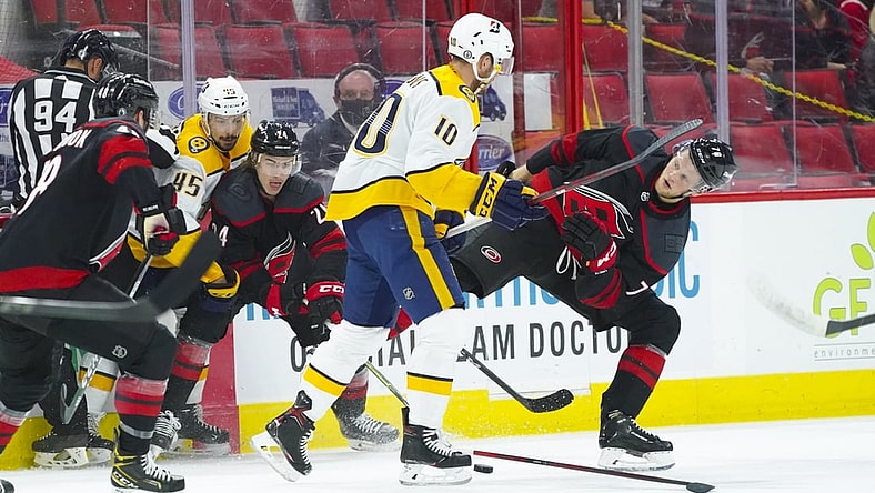 May 25, 2021; Raleigh, North Carolina, USA; Nashville Predators center Colton Sissons (10) checks Carolina Hurricanes left wing Steven Lorentz (78) during the first period in game five of the first round of the 2021 Stanley Cup Playoffs at PNC Arena. Mandatory Credit: James Guillory-USA TODAY Sports