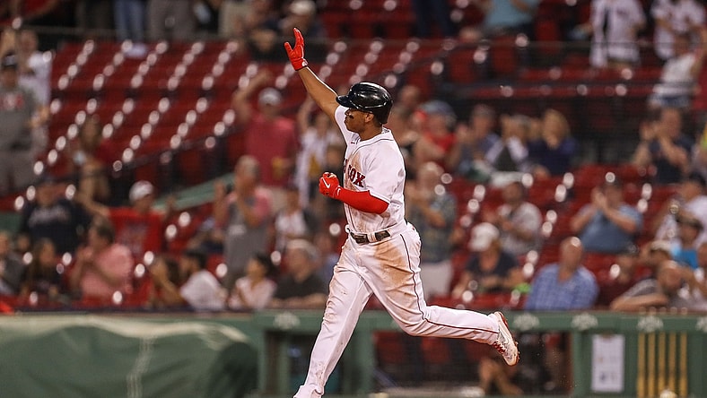 May 26, 2021; Boston, Massachusetts, USA; Boston Red Sox third baseman Rafael Devers (11) reacts after hitting a home run during the fourth inning against the Atlanta Braves at Fenway Park. Mandatory Credit: Paul Rutherford-USA TODAY Sports