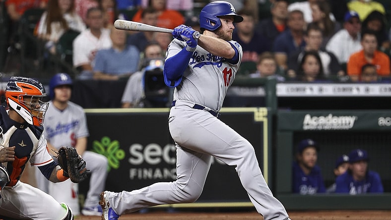 May 26, 2021; Houston, Texas, USA; Los Angeles Dodgers second baseman Max Muncy (13) hits an RBI single during the third inning against the Houston Astros at Minute Maid Park. Mandatory Credit: Troy Taormina-USA TODAY Sports