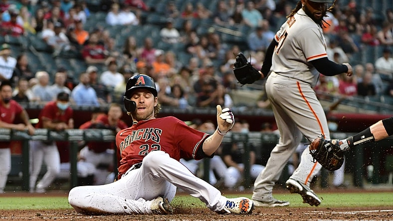 May 26, 2021; Phoenix, Arizona, USA; Arizona Diamondbacks right fielder Josh Reddick (22) scores as San Francisco Giants starting pitcher Johnny Cueto (47) looks on in the second inning at Chase Field. Mandatory Credit: Matt Kartozian-USA TODAY Sports