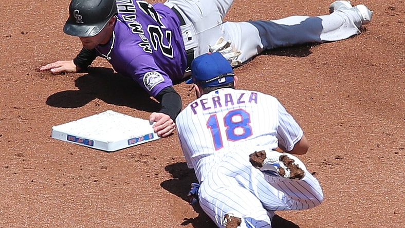 May 27, 2021; New York City, New York, USA; Colorado Rockies third baseman Ryan McMahon (24) steals second ahead of a tag by New York Mets second baseman Jose Peraza (18) during the first inning at Citi Field. Mandatory Credit: Brad Penner-USA TODAY Sports