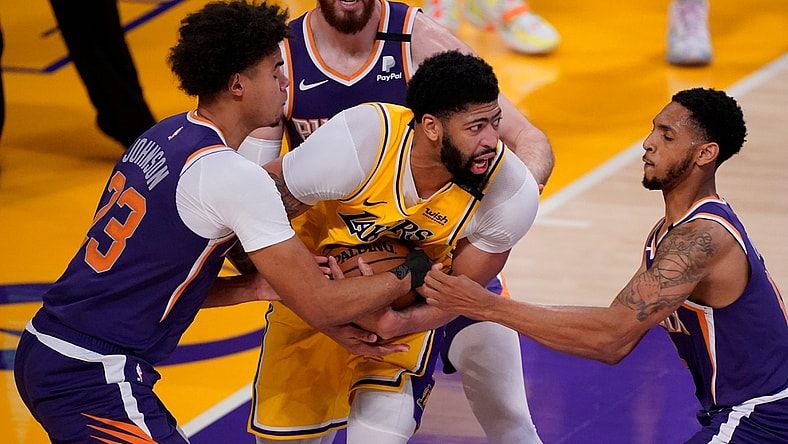 May 27, 2021; Los Angeles, California, USA; Los Angeles Lakers forward Anthony Davis (3) is surrounded by Phoenix Suns forward Cameron Johnson (23), forward Frank Kaminsky (8) and guard Cameron Payne (15) during the fourth quarter of game three in the first round of the 2021 NBA Playoffs at Staples Center. Mandatory Credit: Robert Hanashiro-USA TODAY Sports
