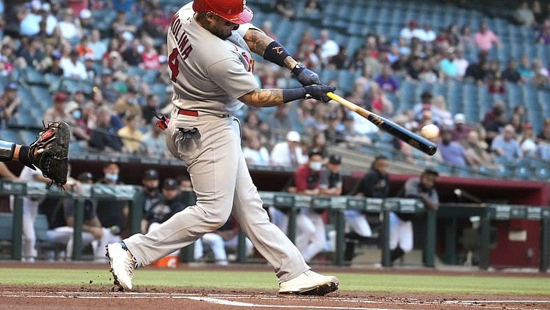 May 28, 2021; Phoenix, Arizona, USA; St. Louis Cardinals catcher Yadier Molina (4) hits an RBI double against the Arizona Diamondbacks in the first inning at Chase Field. Mandatory Credit: Rick Scuteri-USA TODAY Sports