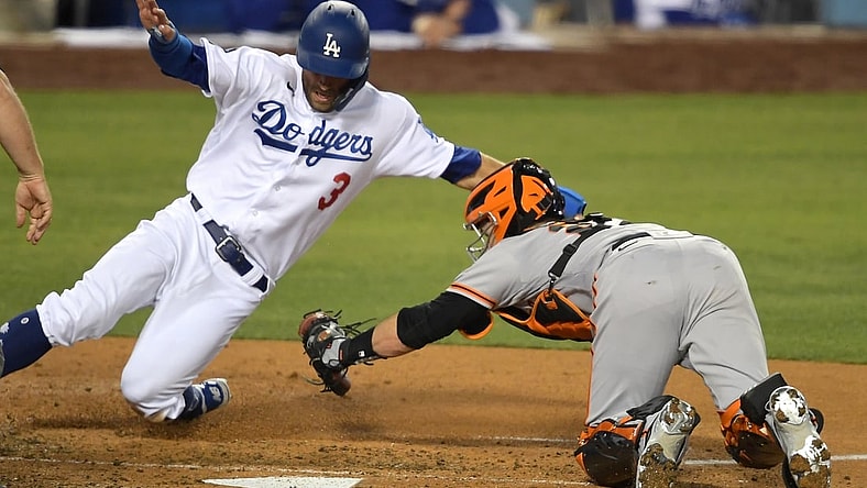 May 28, 2021; Los Angeles, California, USA; Los Angeles Dodgers left fielder Chris Taylor (3) is tagged out at the plate by San Francisco Giants catcher Buster Posey (28) during the fourth inning at Dodger Stadium. Mandatory Credit: Jayne Kamin-Oncea-USA TODAY Sports