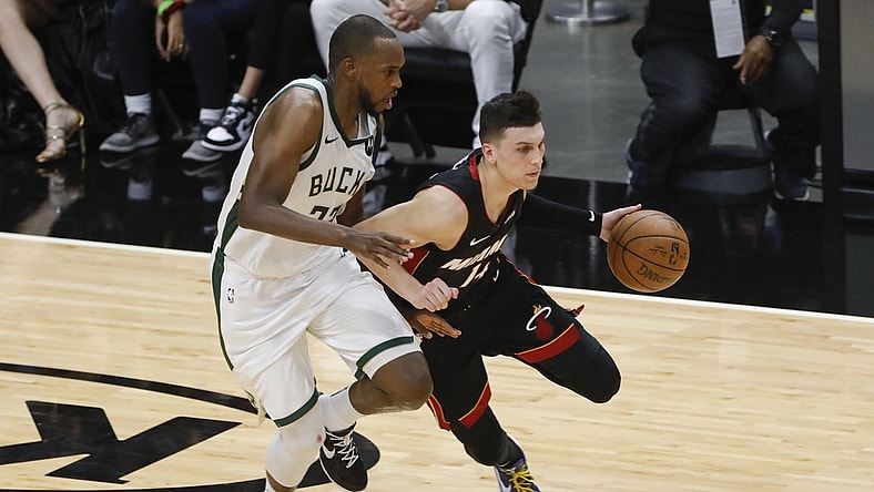 May 29, 2021; Miami, Florida, USA; Miami Heat guard Tyler Herro (14) dribbles the basketball around Milwaukee Bucks forward Khris Middleton (22) during the second quarter of game four in the first round of the 2021 NBA Playoffs at American Airlines Arena. Mandatory Credit: Sam Navarro-USA TODAY Sports