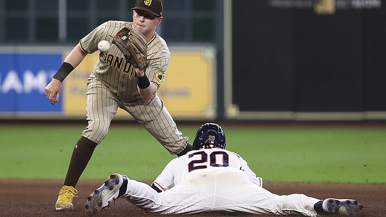 May 29, 2021; Houston, Texas, USA; Houston Astros left fielder Chas McCormick (20) slides into second base safely with a stolen base ahead of the throw to San Diego Padres second baseman Jake Cronenworth (left) during the fourth inning at Minute Maid Park. Mandatory Credit: Troy Taormina-USA TODAY Sports