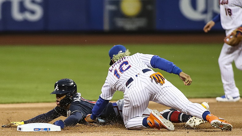 May 29, 2021; New York City, New York, USA; Atlanta Braves right fielder Ronald Acuna Jr. (13) is tagged out by New York Mets shortstop Francisco Lindor (12) trying to steal second base in the first inning at Citi Field. Mandatory Credit: Wendell Cruz-USA TODAY Sports