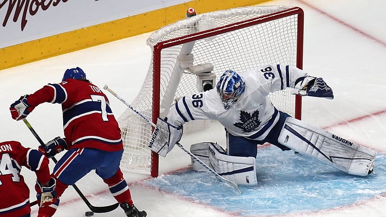 May 29, 2021; Montreal, Quebec, CAN; Montreal Canadiens right wing Tyler Toffoli (73) plays the puck next to Toronto Maple Leafs goaltender Jack Campbell (36) during the first period in game six of the first round of the 2021 Stanley Cup Playoffs at Bell Centre. Mandatory Credit: Jean-Yves Ahern-USA TODAY Sports
