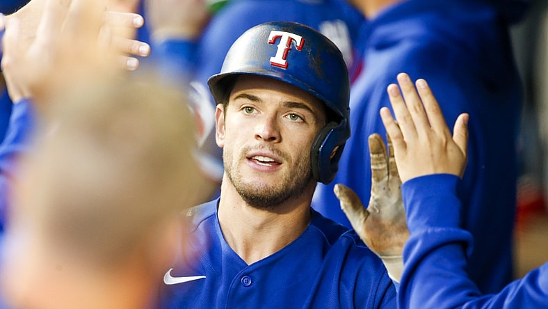 May 29, 2021; Seattle, Washington, USA; Texas Rangers second baseman Nick Solak (15) is greeted in the dugout after hitting an RBI-sacrifice fly against the Seattle Mariners during the fourth inning at T-Mobile Park. Mandatory Credit: Joe Nicholson-USA TODAY Sports