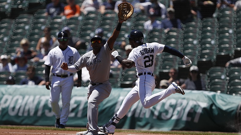 May 30, 2021; Detroit, Michigan, USA; Detroit Tigers center fielder Niko Goodrum (28) safe at first base on a wild throw to New York Yankees first baseman Miguel Andujar (41) during the first inning at Comerica Park. Mandatory Credit: Raj Mehta-USA TODAY Sports