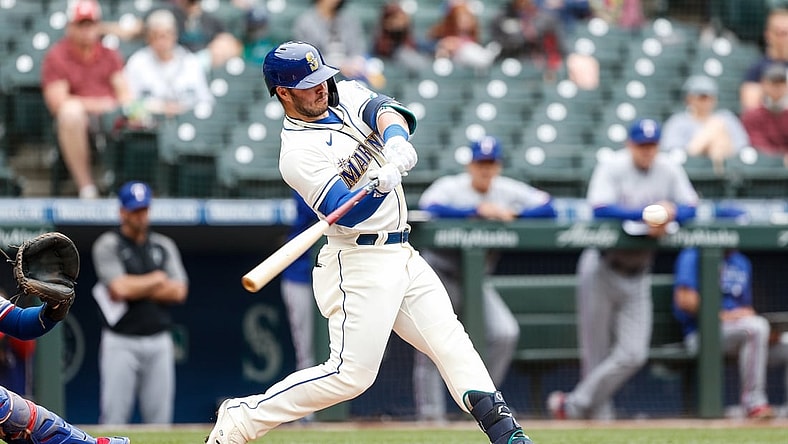 May 30, 2021; Seattle, Washington, USA; Seattle Mariners first baseman Ty France (23) hits an RBI double against the Texas Rangers during the first inning at T-Mobile Park. Mandatory Credit: Jennifer Buchanan-USA TODAY Sports
