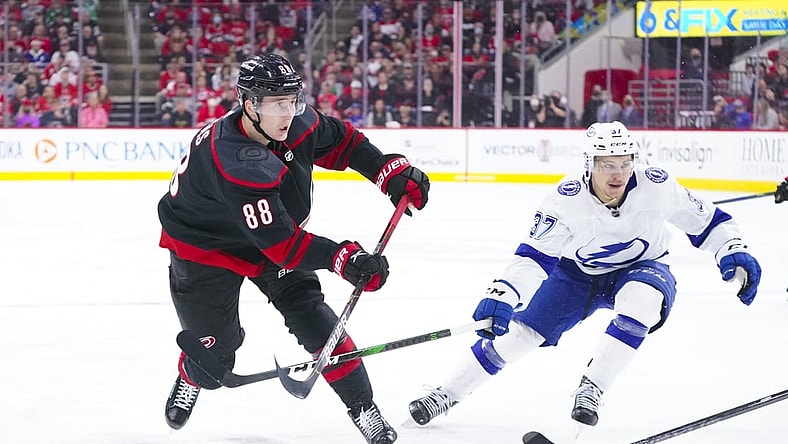 May 30, 2021; Raleigh, North Carolina, USA; Carolina Hurricanes center Martin Necas (88) takes a shot against Tampa Bay Lightning center Yanni Gourde (37) in game one of the second round of the 2021 Stanley Cup Playoffs at PNC Arena. Mandatory Credit: James Guillory-USA TODAY Sports