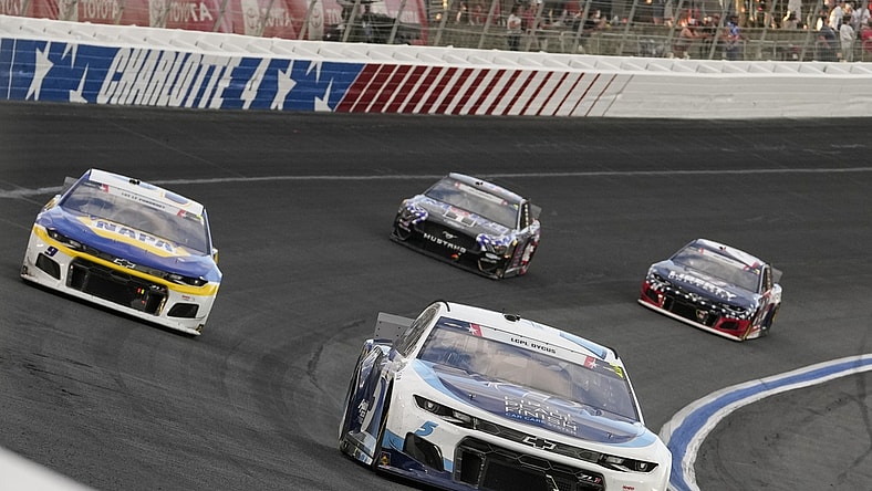 May 30, 2021; Concord, North Carolina, USA; NASCAR Cup Series driver Kyle Larson (5) fends off driver Chase Elliott (9) during the Coca-Cola 600 at Charlotte Motor Speedway. Mandatory Credit: Jim Dedmon-USA TODAY Sports