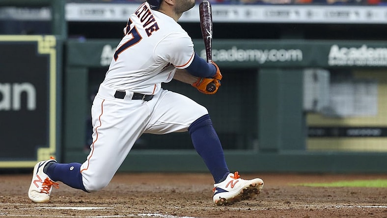 May 31, 2021; Houston, Texas, USA; Houston Astros second baseman Jose Altuve (27) hits a two run home run against the Boston Red Sox in the third inning at Minute Maid Park. Mandatory Credit: Thomas Shea-USA TODAY Sports