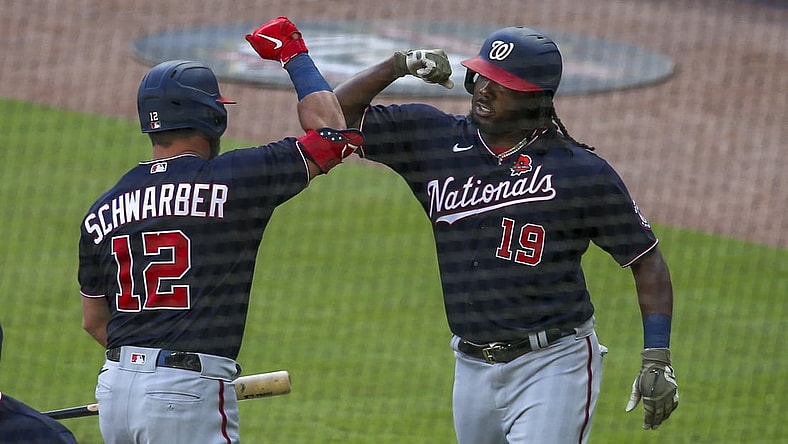 May 31, 2021; Atlanta, Georgia, USA; Washington Nationals first baseman Josh Bell (19) celebrates after a home run with left fielder Kyle Schwarber (12) against the Atlanta Braves in the fourth inning at Truist Park. Mandatory Credit: Brett Davis-USA TODAY Sports