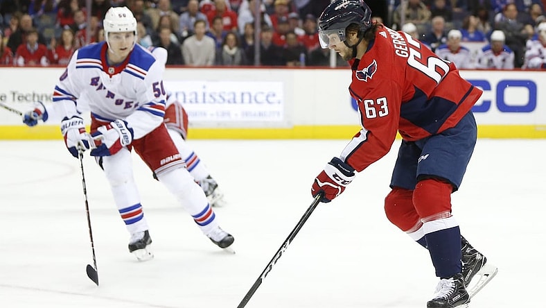 Mar 28, 2018; Washington, DC, USA; Washington Capitals left wing Shane Gersich (63) skates with the puck during his first NHL game in front of New York Rangers center Lias Andersson (50) during the first period at Capital One Arena. Mandatory Credit: Amber Searls-USA TODAY Sports