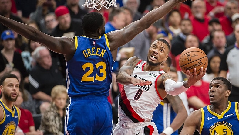 May 20, 2019; Portland, OR, USA; Portland Trail Blazers guard Damian Lillard (0) puts up a shot against Golden State Warriors forward Draymond Green (23) during the second half in game four of the Western conference finals of the 2019 NBA Playoffs at Moda Center. The Warriors won 119-117 in overtime. Mandatory Credit: Troy Wayrynen-USA TODAY Sports