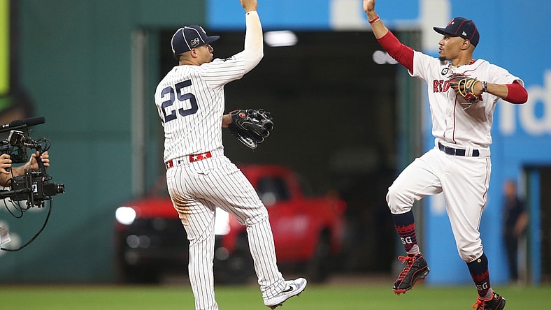 Jul 9, 2019; Cleveland, OH, USA;  American League second baseman Gleyber Torres (25) of the New York Yankees and center fielder Mookie Betts (50) of the Boston Red Sox celebrate after defeating the National League in the 2019 MLB All Star Game at Progressive Field. Mandatory Credit: Charles LeClaire-USA TODAY Sports