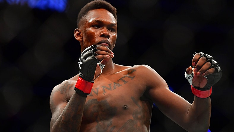 Mar 7, 2020; Las Vegas, Nevada, USA; Israel Adesanya (red gloves) before the match against Yoel Romero (blue gloves) during UFC 248 at T-Mobile Arena. Mandatory Credit: Stephen R. Sylvanie-USA TODAY Sports