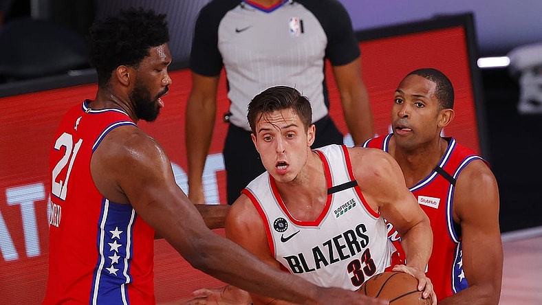 Aug 9, 2020; Lake Buena Vista, Florida, USA;  Zach Collins #33 of the Portland Trail Blazers is pressured by Joel Embiid #21 of the Philadelphia 76ers at Visa Athletic Center at ESPN Wide World Of Sports Complex on August 09, 2020 in Lake Buena Vista, Florida.  Mandatory Credit: Kevin C. Cox/Pool Photo-USA TODAY Sports