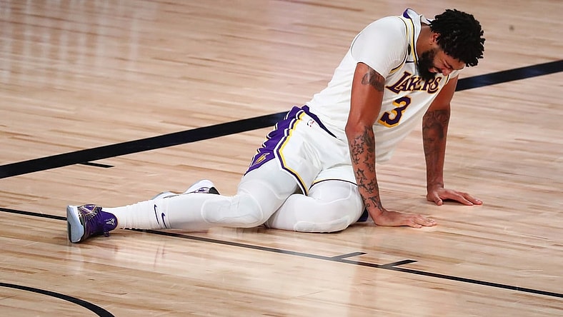 Sep 8, 2020; Lake Buena Vista, Florida, USA; Los Angeles Lakers forward Anthony Davis (3) lies on the floor after suffering an apparent injury with Houston Rockets forward Robert Covington (not picture) during the second half of game three in the second round of the 2020 NBA Playoffs at AdventHealth Arena. Mandatory Credit: Kim Klement-USA TODAY Sports