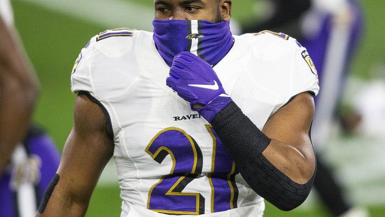 Dec 14, 2020; Cleveland, Ohio, USA; Baltimore Ravens running back Mark Ingram (21) adjusts his face mask before the game against the Cleveland Browns at FirstEnergy Stadium. Mandatory Credit: Scott Galvin-USA TODAY Sports