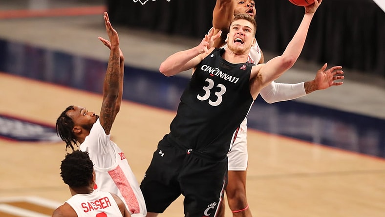 Mar 14, 2021; Fort Worth, TX, USA; Cincinnati Bearcats center Chris Vogt (33) shoots the ball against Houston Cougars forward Reggie Chaney (32) and guard DeJon Jarreau (3) during the second half at Dickies Arena. Mandatory Credit: Ben Ludeman-USA TODAY Sports