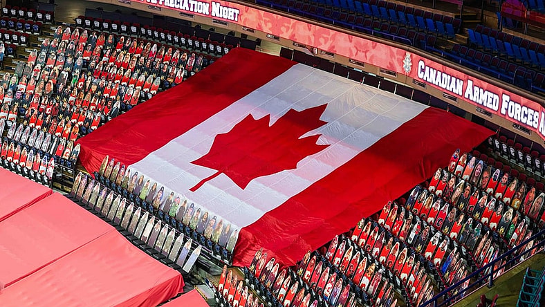 Mar 27, 2021; Calgary, Alberta, CAN; General view of cardboard cutouts of Canadian Armed Forces in front of the Canadian flag for the Canadian Armed Forces Appreciation Night prior to the game between the Calgary Flames and the Winnipeg Jets at Scotiabank Saddledome. Mandatory Credit: Sergei Belski-USA TODAY Sports