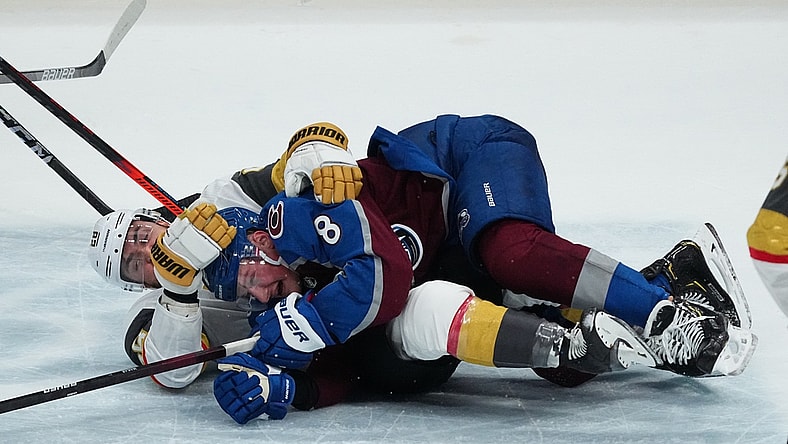 May 30, 2021; Denver, Colorado, USA; Vegas Golden Knights left wing William Carrier (28) takes down Colorado Avalanche defenseman Cale Makar (8) in the second period of game one in the second round of the 2021 Stanley Cup Playoffs at Ball Arena. Mandatory Credit: Ron Chenoy-USA TODAY Sports