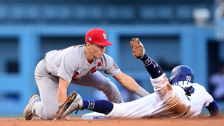 May 31, 2021; Los Angeles, California, USA; Los Angeles Dodgers right fielder Mookie Betts (50) is caught stealing second against St. Louis Cardinals second baseman Tommy Edman (19) to end the third inning at Dodger Stadium. Mandatory Credit: Gary A. Vasquez-USA TODAY Sports