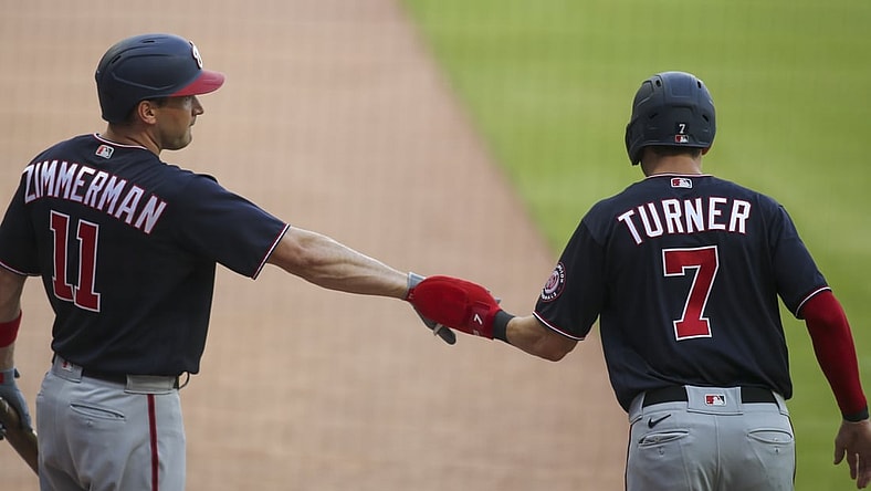 Jun 1, 2021; Atlanta, Georgia, USA; Washington Nationals shortstop Trea Turner (7) celebrates with first baseman Ryan Zimmerman (11) after scoring against the Atlanta Braves in the first inning at Truist Park. Mandatory Credit: Brett Davis-USA TODAY Sports