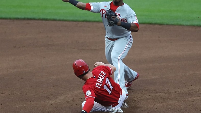 Jun 1, 2021; Cincinnati, Ohio, USA; Cincinnati Reds shortstop Kyle Farmer (17) is forced out a second as  Philadelphia Phillies second baseman Jean Segura (2) throws to first to complete a double play during the second inning at Great American Ball Park. Mandatory Credit: David Kohl-USA TODAY Sports