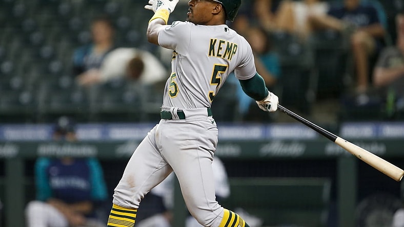 Jun 1, 2021; Seattle, Washington, USA; Oakland Athletics second baseman Tony Kemp (5) hits an RBI-sacrifice fly against the Seattle Mariners during the seventh inning at T-Mobile Park. Mandatory Credit: Joe Nicholson-USA TODAY Sports