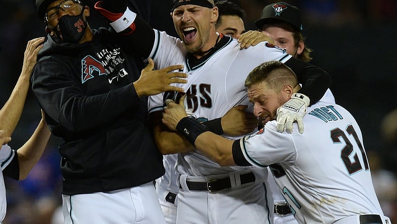 Jun 1, 2021; Phoenix, Arizona, USA; Arizona Diamondbacks right fielder Josh Reddick (22) celebrates with teammates after his walk off two run RBI hit against the New York Mets during the tenth inning at Chase Field. Mandatory Credit: Joe Camporeale-USA TODAY Sports