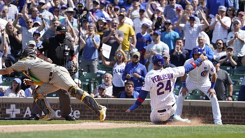 Jun 2, 2021; Chicago, Illinois, USA; Chicago Cubs left fielder Joc Pederson (24 scores as San Diego Padres catcher Webster Rivas (48) takes a late throw during the fifth inning )at Wrigley Field. Mandatory Credit: David Banks-USA TODAY Sports