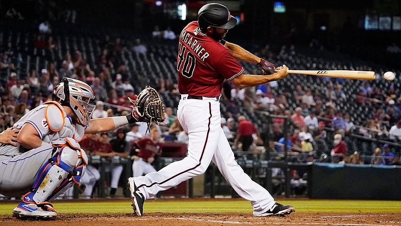 Jun 2, 2021; Phoenix, Arizona, USA; Arizona Diamondbacks starting pitcher Madison Bumgarner (40) hits an RBI-single off New York Mets starting pitcher David Peterson (23) in the first inning at Chase Field. Mandatory Credit: Rob Schumacher-Arizona Republic

Mlb N Y Mets At Arizona Diamondbacks