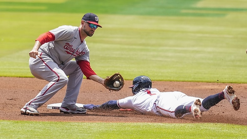 Jun 3, 2021; Cumberland, Georgia, USA; Atlanta Braves second baseman Ozzie Albies (1) steals second base ahead of a tag by Washington Nationals shortstop Jordy Mercer (27) during the first inning at Truist Park. Mandatory Credit: Dale Zanine-USA TODAY Sports