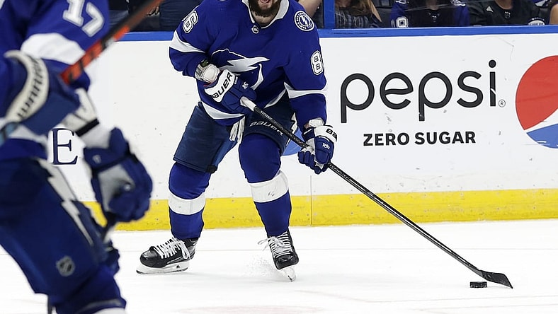 Jun 3, 2021; Tampa, Florida, USA; Tampa Bay Lightning right wing Nikita Kucherov (86) passes the puck against the Carolina Hurricanes during the third period in game three of the second round of the 2021 Stanley Cup Playoffs at Amalie Arena. Mandatory Credit: Kim Klement-USA TODAY Sports