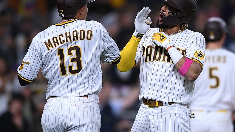 Jun 3, 2021; San Diego, California, USA; San Diego Padres shortstop Fernando Tatis Jr. (right) celebrates with  third baseman Manny Machado (13) after hitting a two-run home run against the New York Mets during the third inning at Petco Park. Mandatory Credit: Orlando Ramirez-USA TODAY Sports