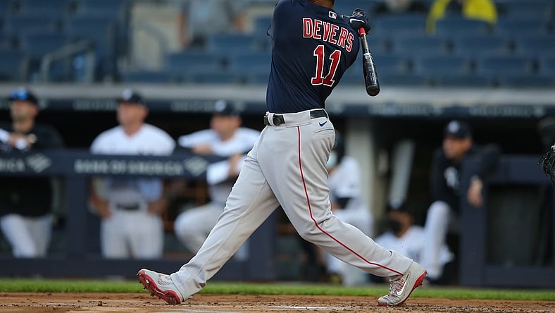 Jun 4, 2021; Bronx, New York, USA; Boston Red Sox third baseman Rafael Devers (11) follows through on a three run home run against the New York Yankees during the first inning at Yankee Stadium. Mandatory Credit: Brad Penner-USA TODAY Sports