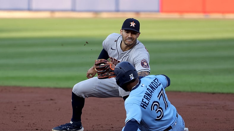 Jun 4, 2021; Buffalo, New York, USA;  Houston Astros shortstop Carlos Correa (1) tags out Toronto Blue Jays right fielder Teoscar Hernandez (37) as he tries to steal second base during the second inning at Sahlen Field. Mandatory Credit: Timothy T. Ludwig-USA TODAY Sports